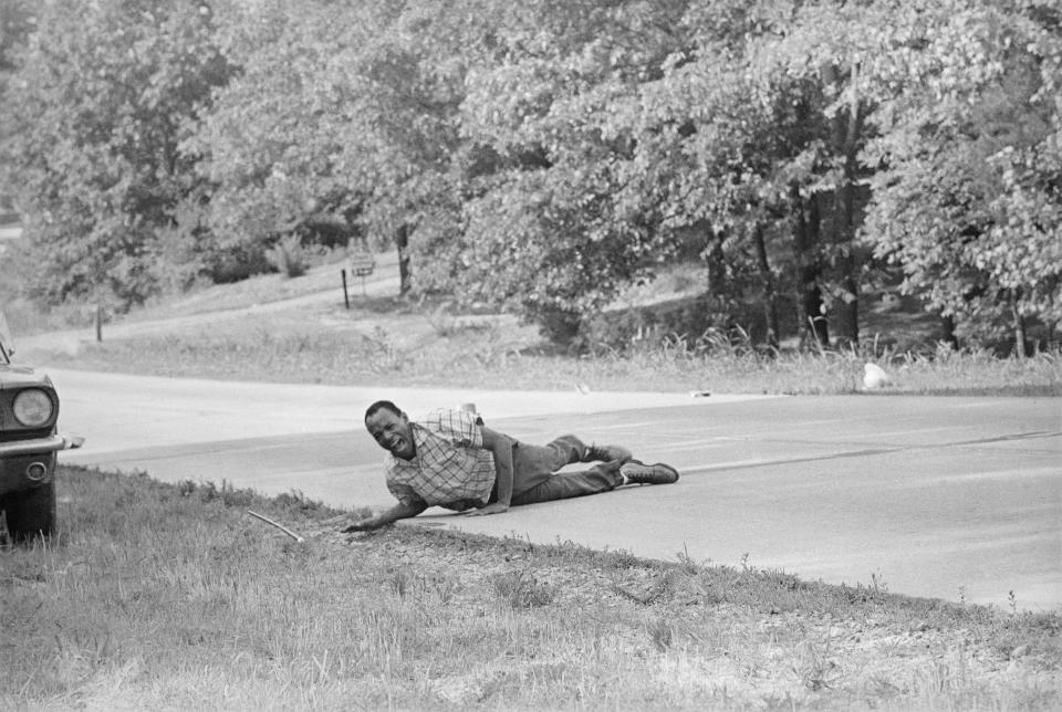 FILE - In this June 6, 1966, file photo, civil rights activist James Meredith grimaces in pain as he pulls himself across Highway 51 after being shot in Hernando, Miss., during his Walk Against Fear. "Walk Against Fear: James Meredith," scheduled to air Thursday, Oct. 1, 2020, on the Smithsonian Channel, examines the life of a U.S. Air Force veteran-turn-human right agitator whose admission into the University of Mississippi forced President John F. Kennedy to send federal troops into the state to quell a white supremacy uprising. It was one of the most violent moments of the Civil Rights Movement and it forever changed life in the American Deep South. (AP Photo/Jack Thornell, File)