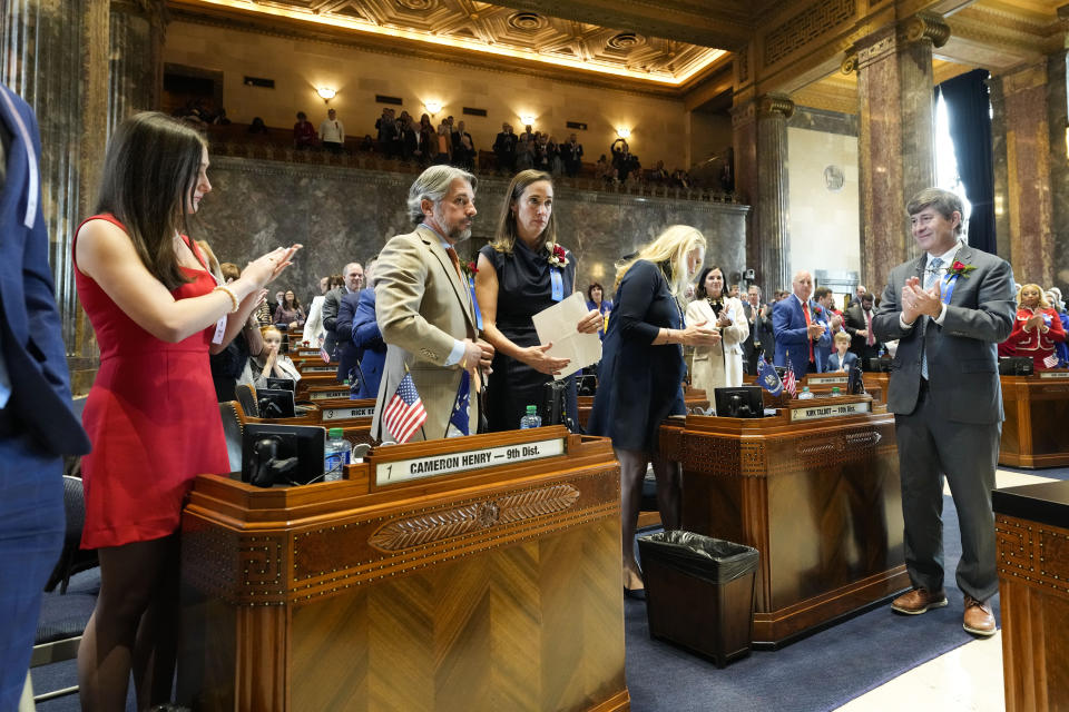 Senate President Cameron Henry, second left, receives applause from Republican senator Kirk Talbot, right, during the swearing in of the Louisiana state legislature in Baton Rouge, La., Monday, Jan. 8, 2024. (AP Photo/Gerald Herbert, Pool)