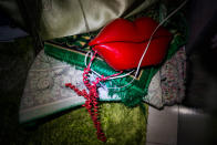 <p>A phone shaped like lips and a prayer rug sit in the corner during a blackout. (Photograph by Monique Jaques) </p>