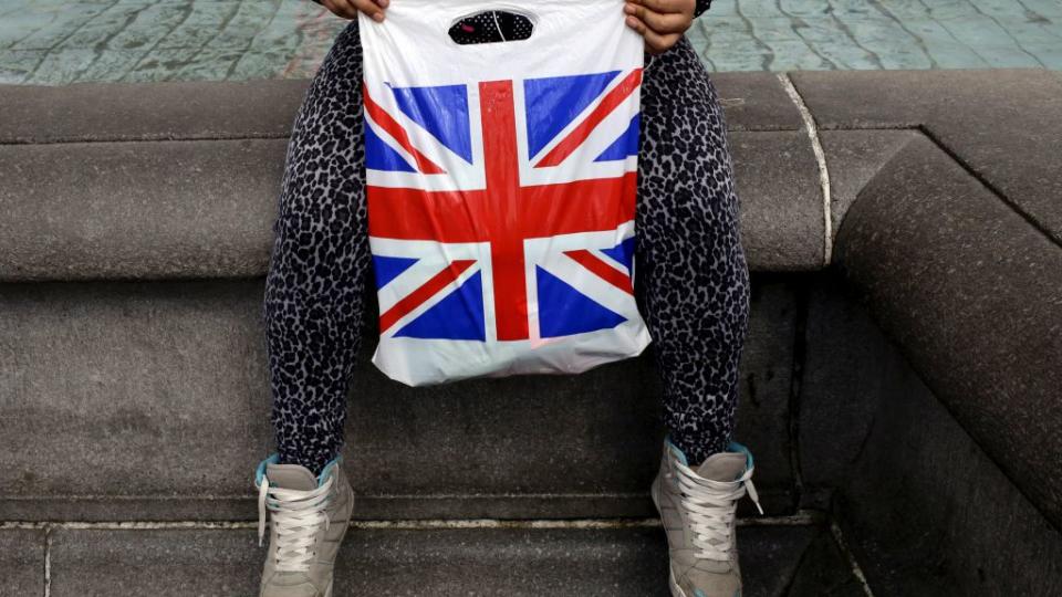 A woman holds a Union Flag shopping bag in London, Britain April 23, 2016. REUTERS/Kevin Coombs/File Photo