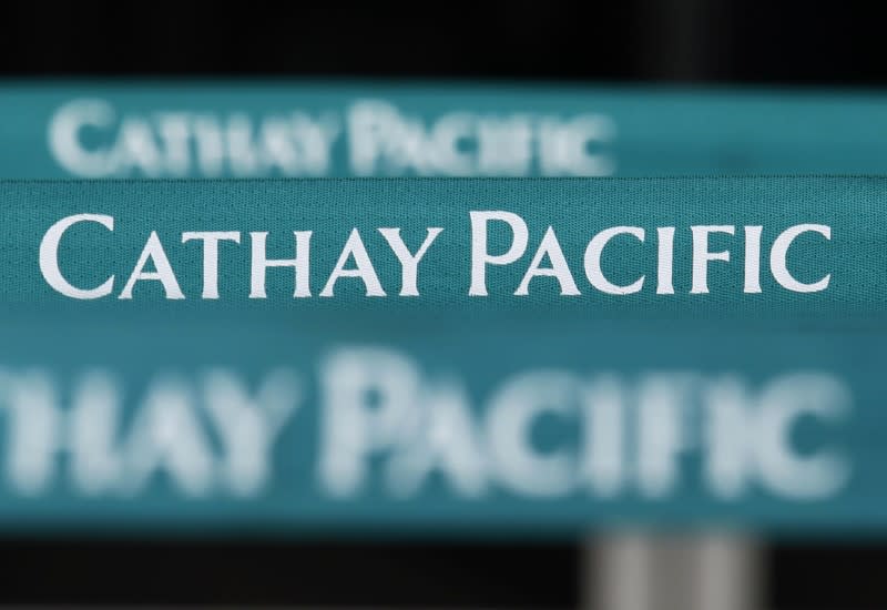 FILE PHOTO: Lined up banners are seen at a city check-in counter of Cathay Pacific Airways in downtown Hong Kong August 8, 2012. REUTERS/Bobby Yip