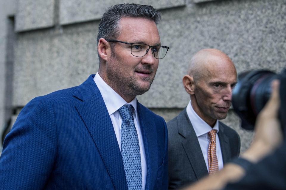 FILE - Trevor Milton, left, leaves the Thurgood Marshall United States Courthouse, Sept. 12, 2022, in New York. Milton was sentenced Monday, Dec. 18, 2023, to four years in prison for his conviction for exaggerating claims about his company's production of zero-emission 18-wheel trucks, causing investors to lose hundreds of thousands of dollars. (AP Photo/Brittainy Newman, File)