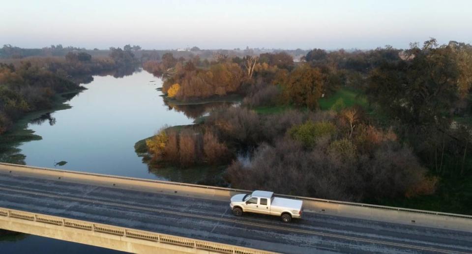 The Tuolumne River passes under the Deer Road bridge at Foxx Grove Park in Hughson, Calif., Dec. 1, 2021.