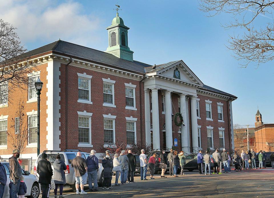 Hundreds show up for a COVID booster shot clinic at Braintree Town Hall on Monday, Dec. 6, 2021.