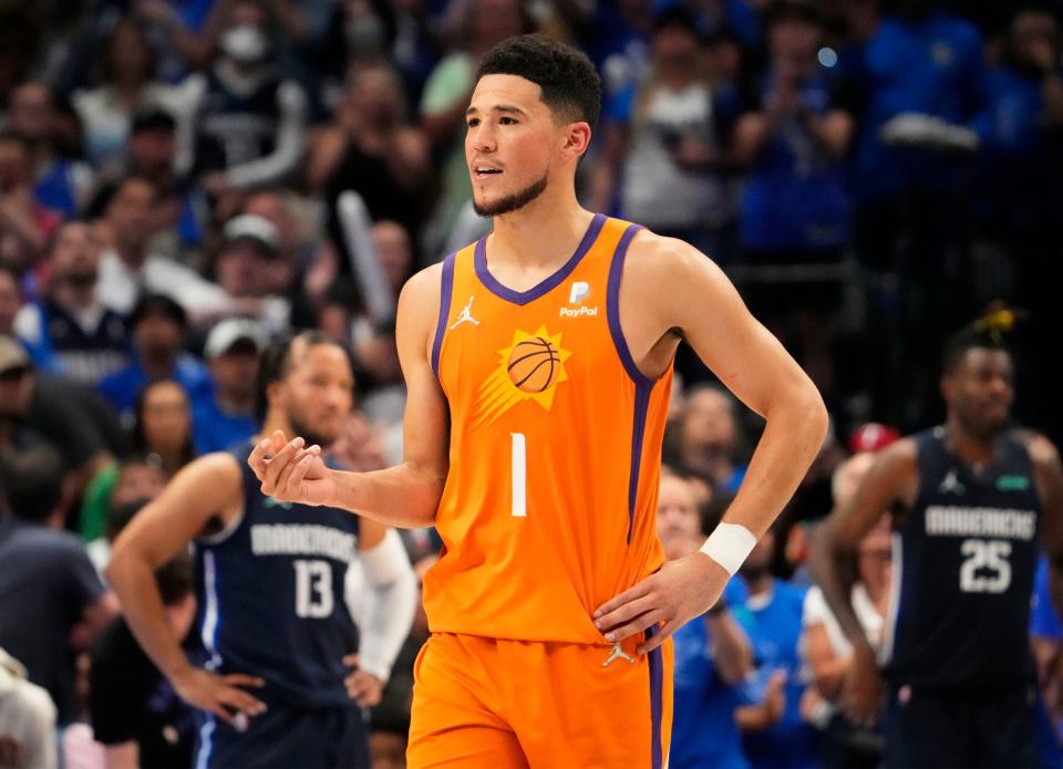 May 8, 2022; Dallas, Texas, USA;  Phoenix Suns guard Devin Booker (1) makes a hand gesture to the Dallas Mavericks fans during game four of the second round for the 2022 NBA playoffs at American Airlines Center.