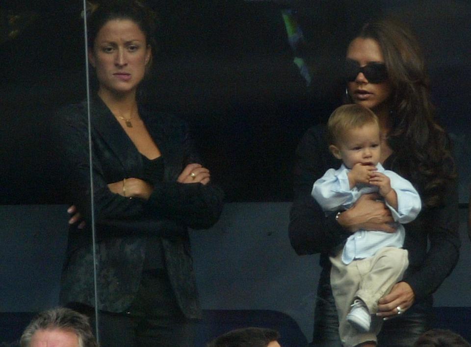 Victoria Beckham holds son Romeo beside PA Rebecca Loos during the Spanish Primera Liga match between Real Madrid and Valladolid in 2003. (Getty Images)