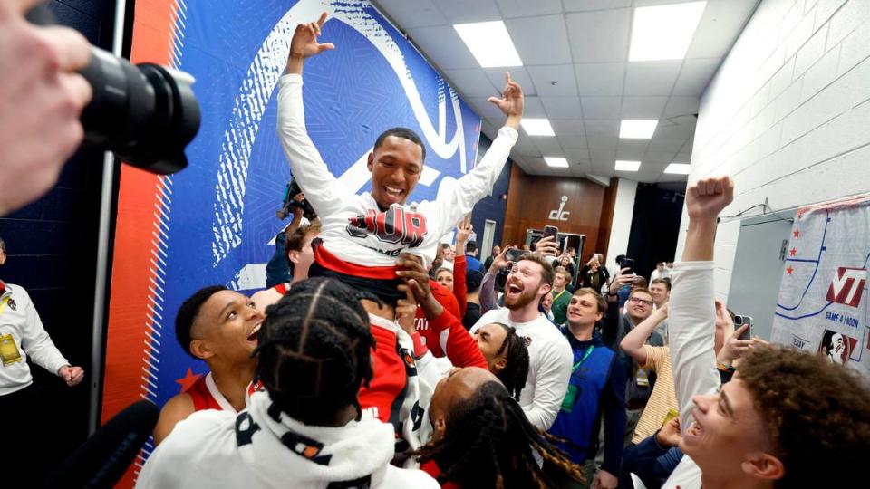 N.C. State’s KJ Keatts (13) is lifted up after placing the Wolfpack sticker on the board after N.C. State’s 74-69 victory over Duke in the quarterfinal round of the 2024 ACC Men’s Basketball Tournament at Capital One Arena in Washington, D.C., Thursday, March 14, 2024. Ethan Hyman/ehyman@newsobserver.com