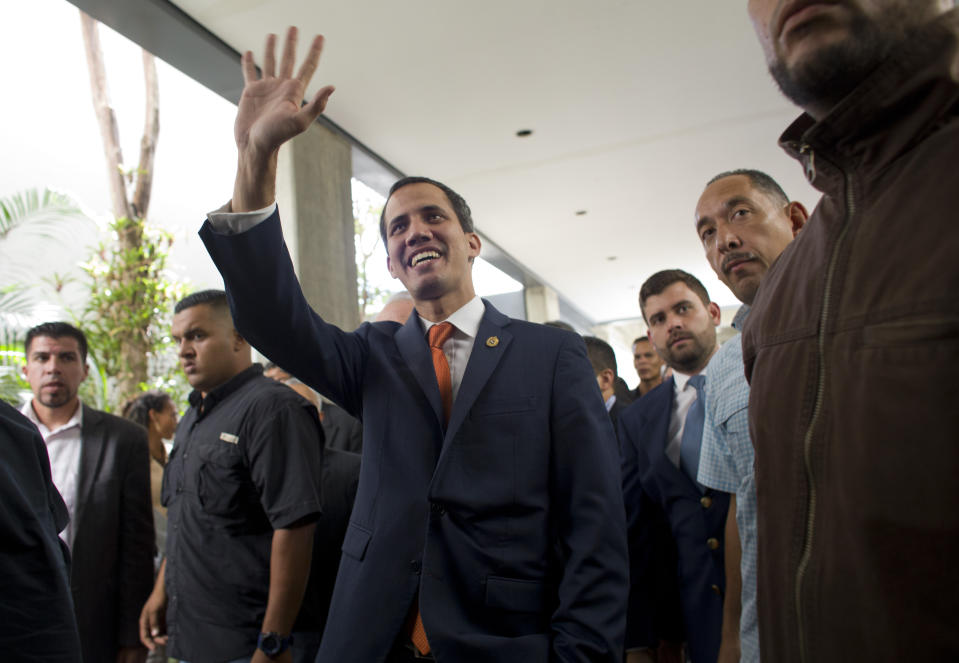 Venezuela's self-proclaimed interim president Juan Guaido, center, greets well-wishers upon his arrival to attend an economic forum, in Caracas, Venezuela, Friday, Feb. 15, 2019. The Trump administration is sending another large shipment of humanitarian aid to the Venezuelan border in Colombia, for the first time using U.S. military aircraft as it increases pressure on Nicolas Maduro to give up power, according to a State Department email sent to Congress. (AP Photo/Ariana Cubillos)