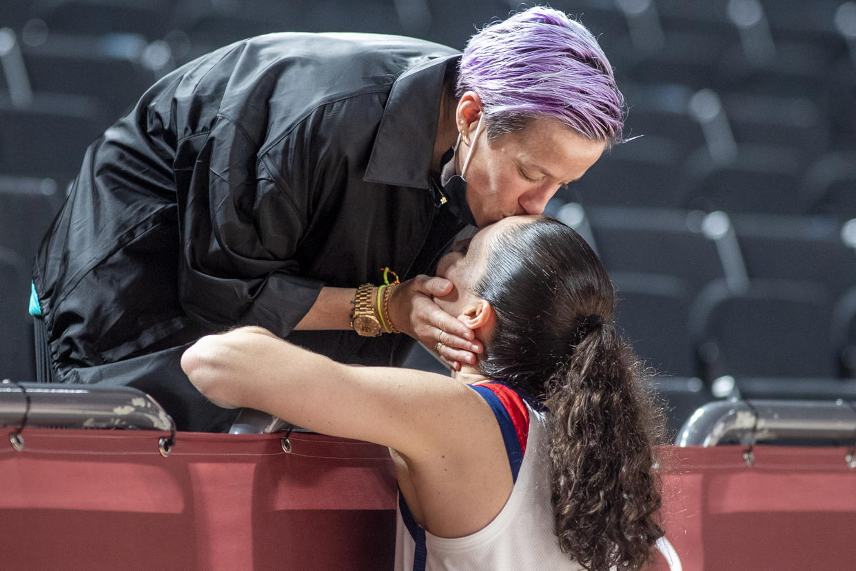 Megan Rapinoe kisses Sue Bird after the U.S. women's basketball team won the 2020 gold medal in Tokyo, Japan. (Tim Clayton/Corbis via Getty Images)