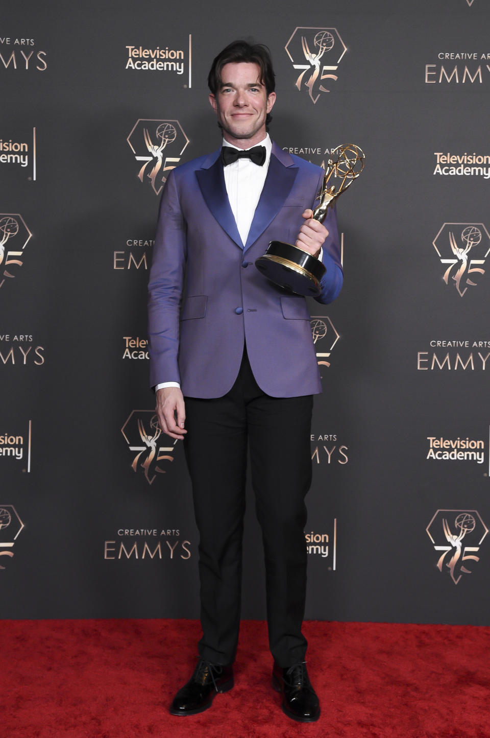 John Mulaney poses in the press room with the award for outstanding writing for a variety special for "Baby J" during night two of the Creative Arts Emmy Awards on Sunday Jan. 7, 2024, at the Peacock Theater in Los Angeles. (Photo by Richard Shotwell/Invision/AP)