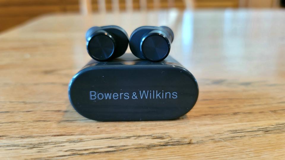 The Bowers & Wilkins PI5 resting on top of their charging case