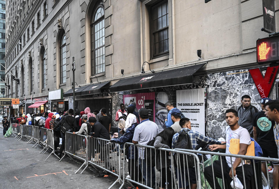 Migrants line up outside Roosevelt Hotel in New York City while waiting for placement inside a shelter that is at full capacity on Aug. 2, 2023. / Credit: Fatih Aktas/Anadolu Agency via Getty Images