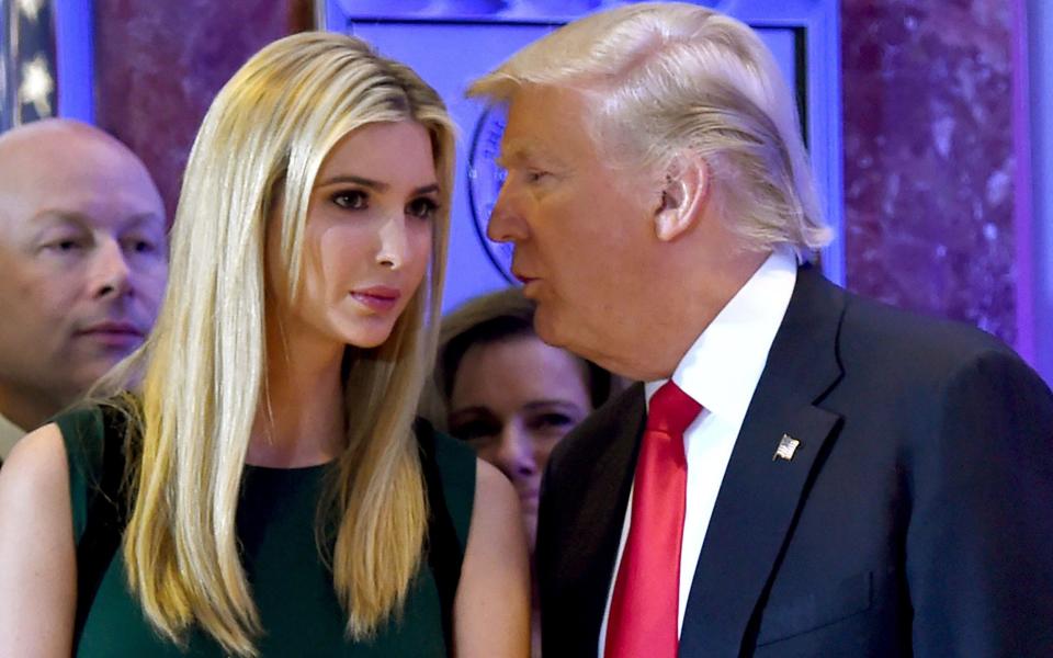 US President-elect Donald Trump as he whispers to his daughter - Credit: TIMOTHY A. CLARY /AFP