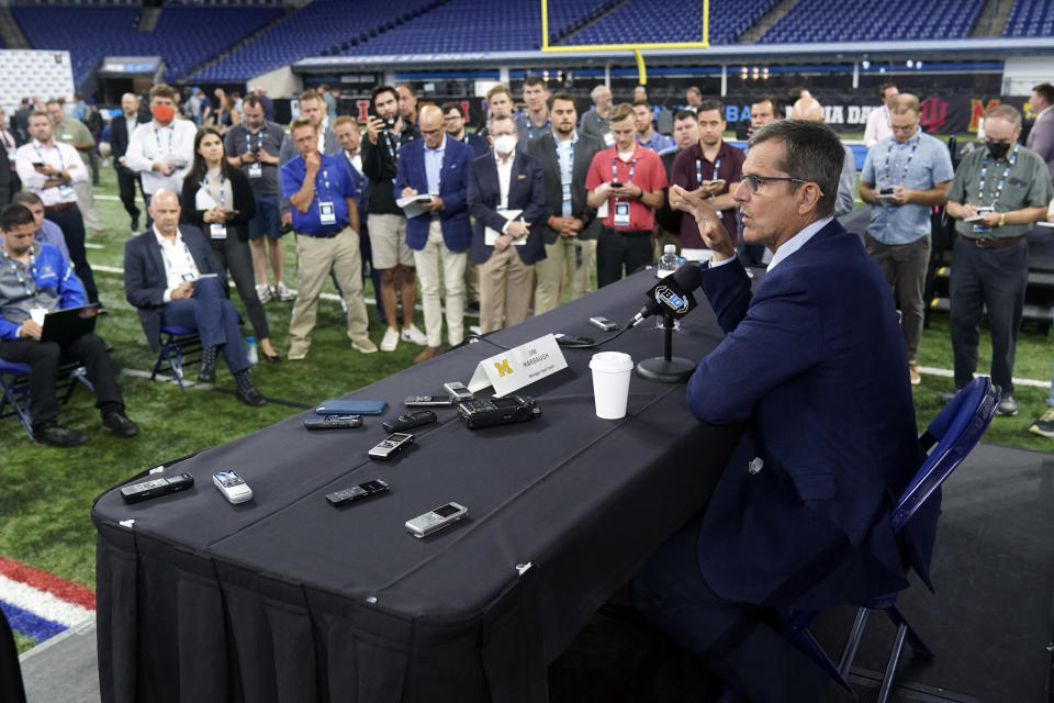 Michigan head coach Jim Harbaugh talks to reporters during an NCAA college football news conference at the Big Ten Conference media days, at Lucas Oil Stadium, Tuesday, July 26, 2022, in Indianapolis. (AP Photo/Darron Cummings)