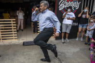 Fabio Rodolfo Vasquez dances with his wife, Maria Moreno, outside of frame, at a promotional event outside a coffee shop, on the outskirts of Guatemala City, Saturday, Sept. 19, 2020. The couple entered an online dance contest during the new coronavirus pandemic to help them cope with the recent death of their daughter — and won it. (AP Photo/Moises Castillo)