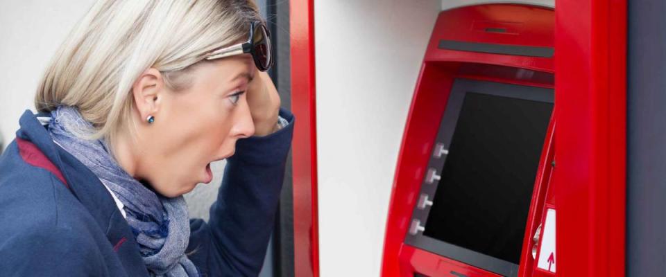 Shocked woman looking at her bank account balance