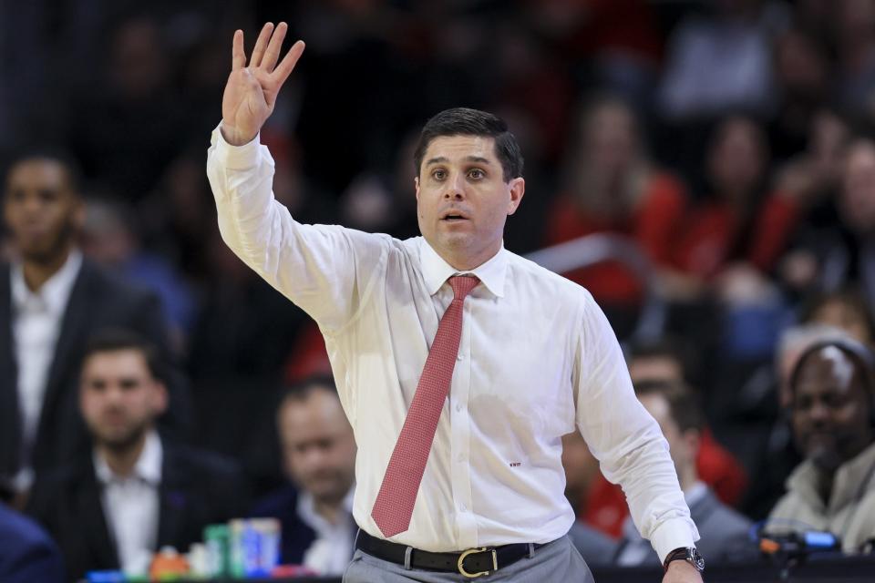 Cincinnati Bearcats head coach Wes Miller signals to his team downcourt in the game against the Temple Owls in the first half at Fifth Third Arena.