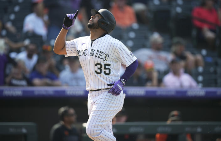Colorado Rockies' Elias Diaz gestures as he crosses home plate after hitting a solo home run off San Francisco Giants relief pitcher Zack Littell during the sixth inning of a baseball game Wednesday, Sept. 8, 2021, in Denver. (AP Photo/David Zalubowski)