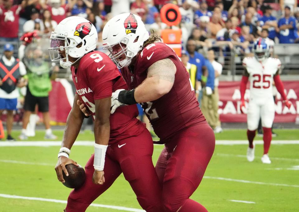 Arizona Cardinals quarterback Joshua Dobbs (9) celebrates his rushing touchdown with guard Hjalte Froholdt (72) against the New York Giants in the first half at State Farm Stadium in Glendale on Sept. 17, 2023.