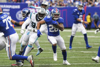 New York Giants' Devontae Booker (28) rushes past Carolina Panthers' Daviyon Nixon (94) during the second half of an NFL football game, Sunday, Oct. 24, 2021, in East Rutherford, N.J. (AP Photo/Bill Kostroun)