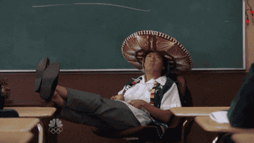 Person wearing a large sombrero and school uniform sitting with feet on desk in a classroom setting. Text reads "I'll allow it"