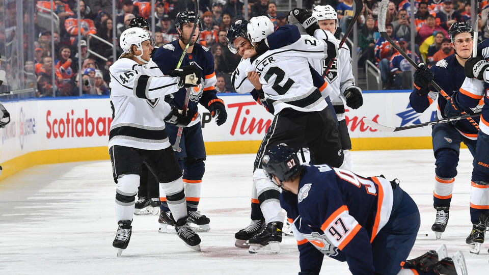 Connor McDavid #97 of the Edmonton Oilers looks on while Darnell Nurse #25 scrums with Alexander Edler #2. (Photo by Andy Devlin/NHLI via Getty Images)