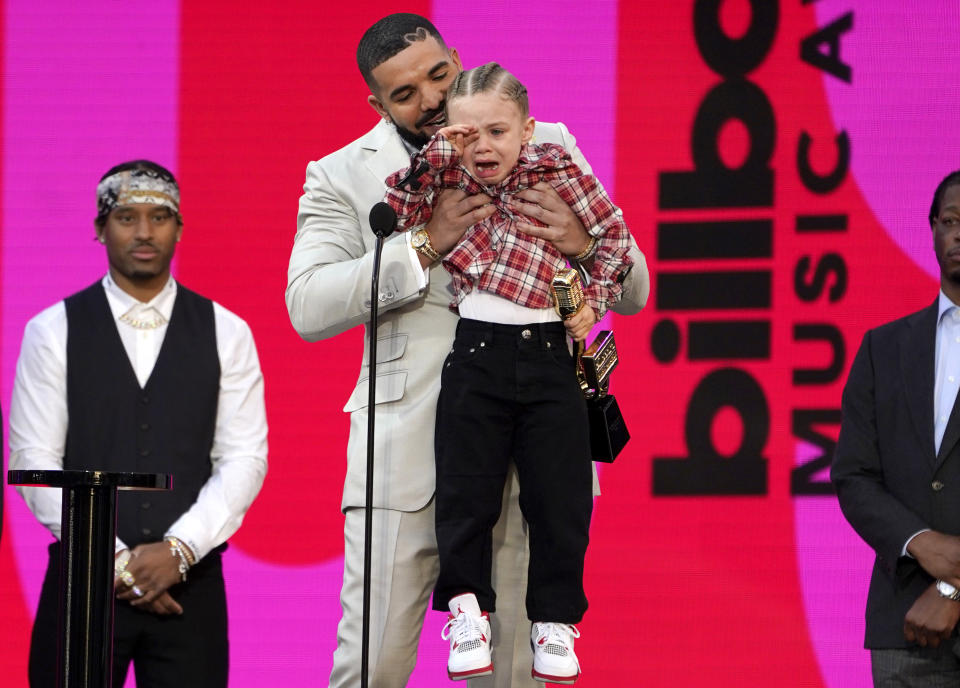 Drake carries his son Adonis Graham as he accepts the artist of the decade award at the Billboard Music Awards on Sunday, May 23, 2021, at the Microsoft Theater in Los Angeles. (AP Photo/Chris Pizzello)