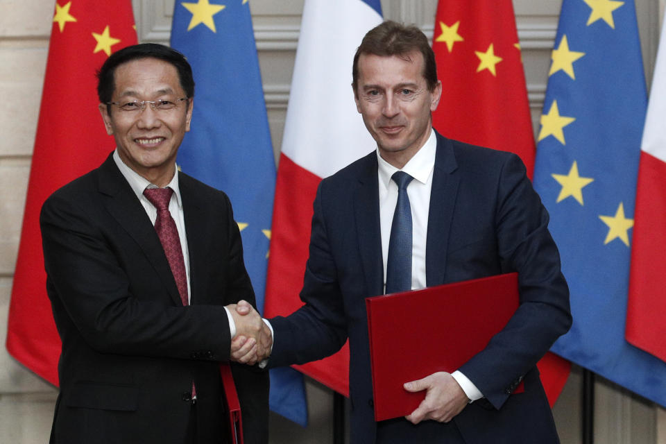 President of Airbus's commercial aircraft business, Guillaume Faury, right, and Chairman of China Aviation Supplies Co. (CASC) Jia Baojun, left, shake hands during an agreement signing ceremony at the Elysee Palace in Paris, France, Monday, March 25, 2019. Chinese President Xi Jinping was greeted with full honors Monday during a state visit to France in which he is expected to sign multibillion-dollar deals on energy, the food industry, transport and other sectors as well as a bilateral statement on climate change. (Yoan Valat/Pool Photo via AP)