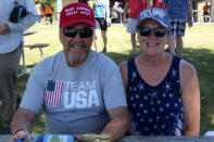 Lynda Thibado and Don Briggs, of Menomonie, Wis., were among supporters of former President Donald Trump who attended a rally organized by pillow salesman-turned conspiracy peddler Mike Lindell in New Richmond, Wis., on Saturday, June 12, 2021. "It's so nice to be around other people that feel the same way you feel," said Briggs. For a few hours last weekend, thousands of Donald Trump’s loyal supporters came together under the blazing sun in a field in western Wisconsin to live in an alternate reality where the former president was still in office — or would soon return. (AP Photo/Jill Colvin)