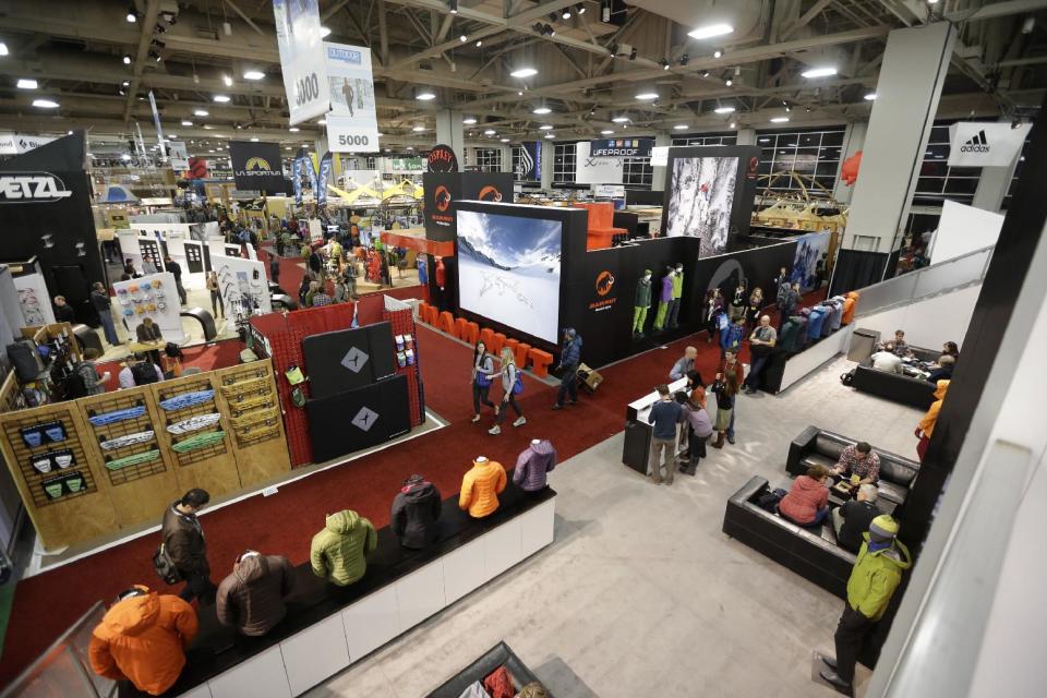 People walk through the Outdoor Retailer Show Wednesday, Jan. 23, 2013, in Salt Lake City. One of the world's largest outdoor gear trade shows will remain in Salt Lake City through at least 2016. Outdoor Retailer, which kicks off its winter expo Wednesday, draws more than 25,000 people to each bi-annual show and pours an estimated $40 million into Utah's economy every year. (AP Photo/Rick Bowmer)