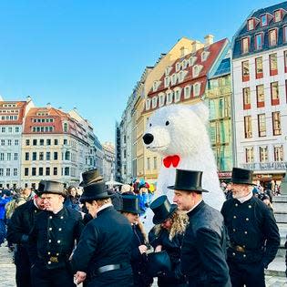 Crowds surround a giant polar bear during a busy time at the Dresden, Germany, Christmas market in December 2023.