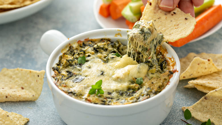 Spinach artichoke dip on table