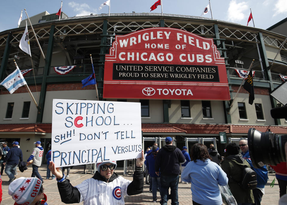 A young Cubs fan who skipped school happened to run into his principal at the game. (AP Photo)