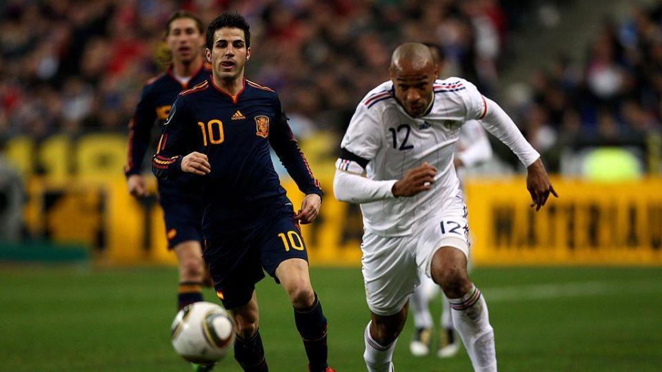 Cesc Fabregas of Spain in action against Thierry Henry of France in 2010