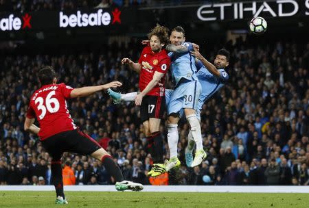 Britain Soccer Football - Manchester City v Manchester United - Premier League - Etihad Stadium - 27/4/17 Manchester City's Sergio Aguero and Nicolas Otamendi in action with Manchester United's Daley Blind Action Images via Reuters / Jason Cairnduff Livepic