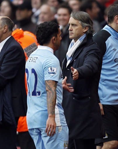Manchester City manager Roberto Mancini (R) and Carlos Tevez on April 8. Mancini, who had previously said Tevez would never play for the club again, has been forced to reverse his stance during the run-in, particularly after ill-discipline saw Mario Balotelli sidelined for three games