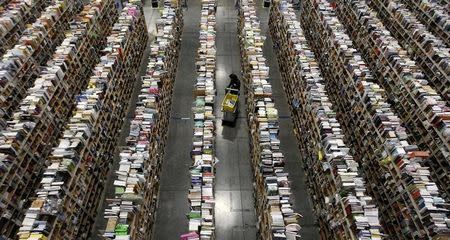 A worker gathers items for delivery from the warehouse floor at Amazon's distribution center in Phoenix, Arizona November 22, 2013. REUTERS/Ralph D. Freso