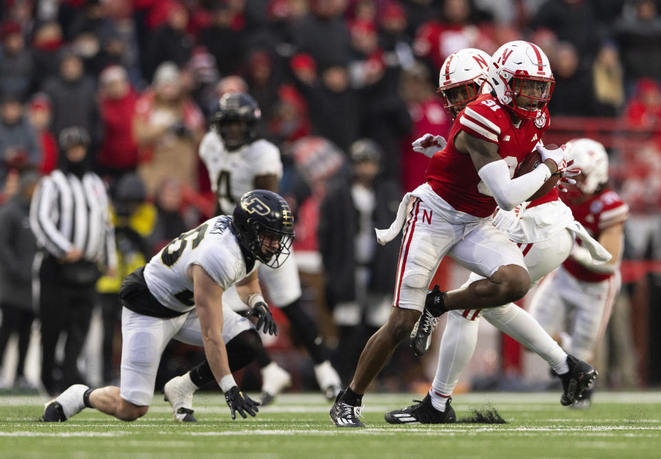 Nebraska's Tommi Hill, right, intercepts a pass intended for Purdue's Andrew Sowinski, left, during the second half of an NCAA college football game Saturday, Oct. 28, 2023, in Lincoln, Neb. (AP Photo/Rebecca S. Gratz)