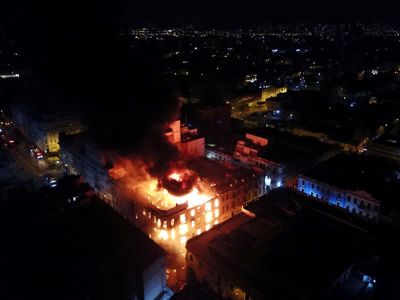 FILE PHOTO: Smoke and flames rise from a building during the 'Take over Lima' march in Lima