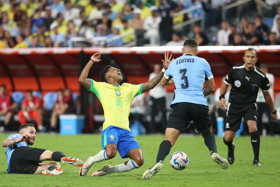 LAS VEGAS, NEVADA - JULY 06: Nahitan Nandez of Uruguay fouls Rodrygo of Brazil during the CONMEBOL Copa America 2024 quarter-final match between Uruguay and Brazil at Allegiant Stadium on July 06, 2024 in Las Vegas, Nevada. (Photo by Ian Maule/Getty Images)