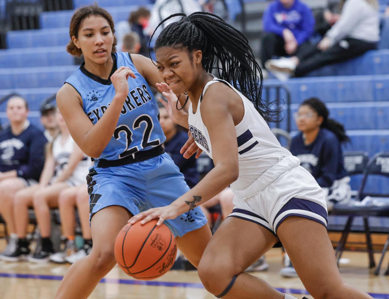 Twinsburg's Genesis Carthen drives baseline on Hudson's Gracie Merrick) during the Tigers' 68-35 home loss to Hudson Saturday.