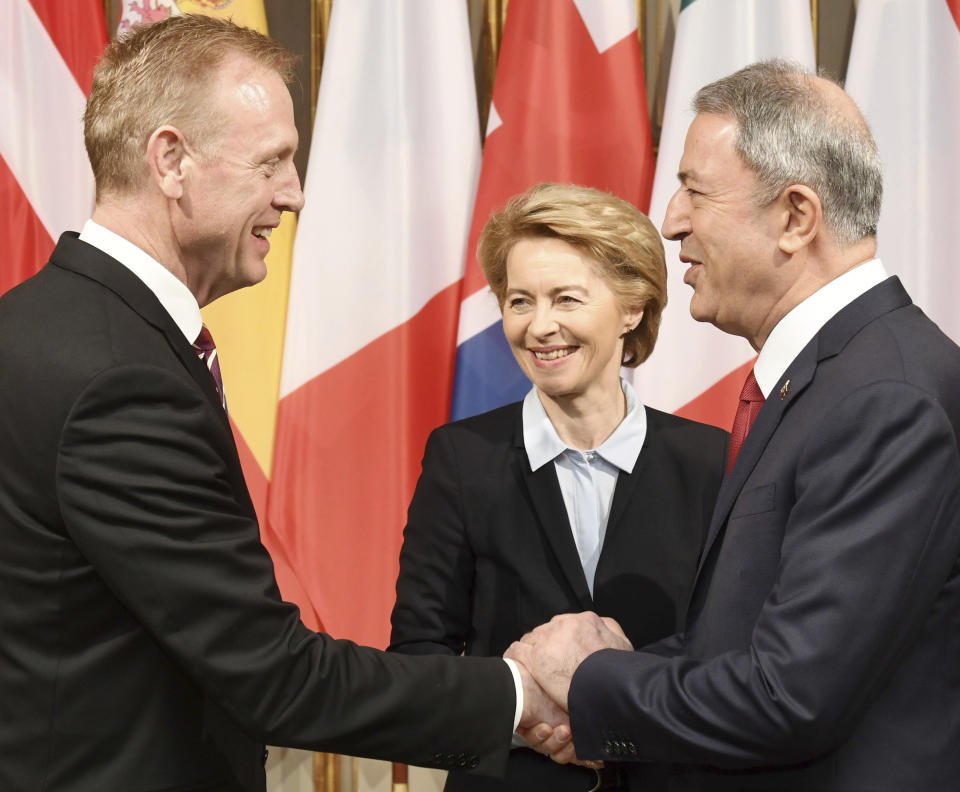 German minster of Defense Ursula von der Leyen, center, smiles when United States Secretary of Defense Patrick Shanahan, left, shakes hands with the Turkish minster of Defense Hulusi Akar, right, during the International Security Conference in Munich, Germany, Friday, Feb. 15, 2019. (Tobias Hase/dpa via AP)