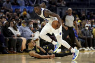 Dallas Mavericks forward Dorian Finney-Smith (10) steals the ball from Golden State Warriors guard Jordan Poole (3) during the first half of an NBA basketball game in San Francisco, Tuesday, Jan. 25, 2022. (AP Photo/Jed Jacobsohn)