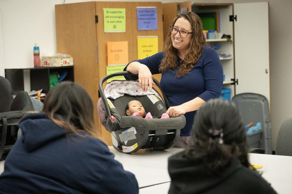 Social worker, Kelli Wright works with Marcos de Niza high school students on car seat safety. Marcos de Niza High School offers Teenage Pregnancy Program (TAPP) to help pregnant and parenting teens finish high school.