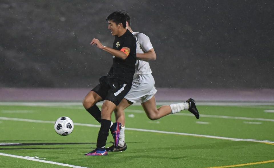 Oak Park's Charles Chowana tries to gain control of the ball during Friday's match against visiting Agoura. Chowana scored in overtime to give the host Eagles a 1-0 win in the Kanan Cup.