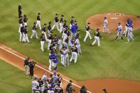 <p>Members of the New York Mets and Miami Marlins meet midfield to embrace in hugs to honor Miami Marlins starting pitcher Jose Fernandez prior to the game at Marlins Park. Mandatory Credit: Jasen Vinlove-USA TODAY Sports </p>