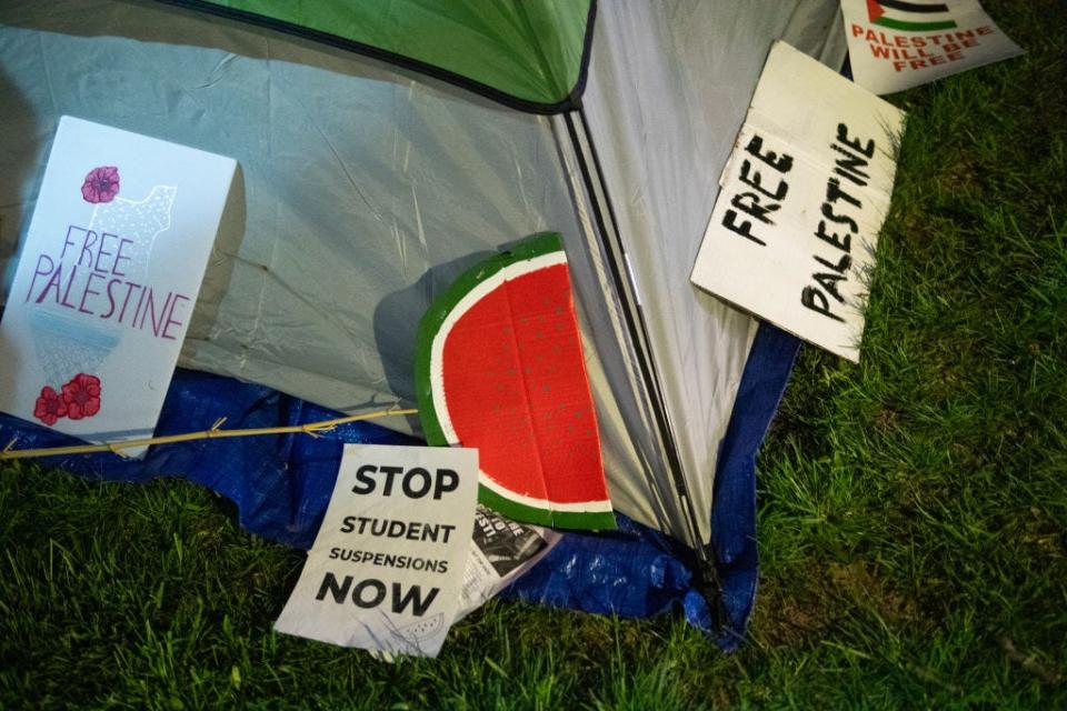 Signs lie next to a tent as pro-Palestinian students and faculty of Drexel University, Temple University and the University of Pennsylvania spend night where they erected an encampment at the University of Pennsylvania campus in Philadelphia on April 25, 2024. College campuses across the US braced for fresh protests by pro-Palestinian students, extending a week of increasingly confrontational standoffs with police, mass arrests and accusations of anti-Semitism. (Photo by Matthew Hatcher / AFP) (Photo by MATTHEW HATCHER/AFP via Getty Images)