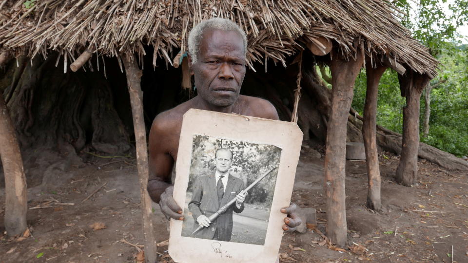 Village elder from Tanna island holds a picture of Britain&#39;s Prince Philip where he is worshipped in Younanen, Vanuatu May 6, 2017. Picture taken May 6, 2017. REUTERS/Jill Gralow REFILE - CORRECTING ID