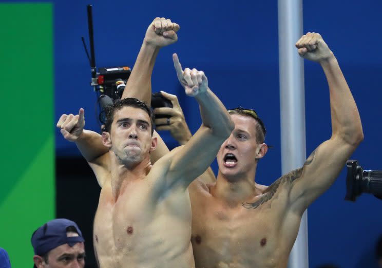 Michael Phelps celebrates with teammates during the U.S. team's 4x100 freestyle race. (Getty) 