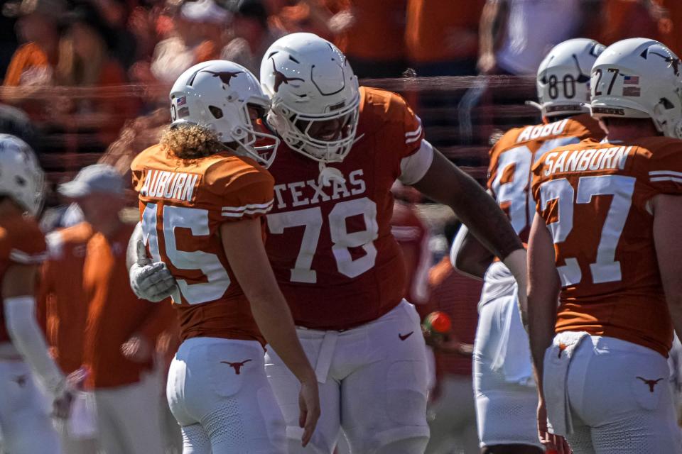 Kelvin Banks Jr., hugging kicker Bert Auburn after a field goal against Kansas State last season, has solidified the left tackle spot for the Longhorns since his first day on campus.